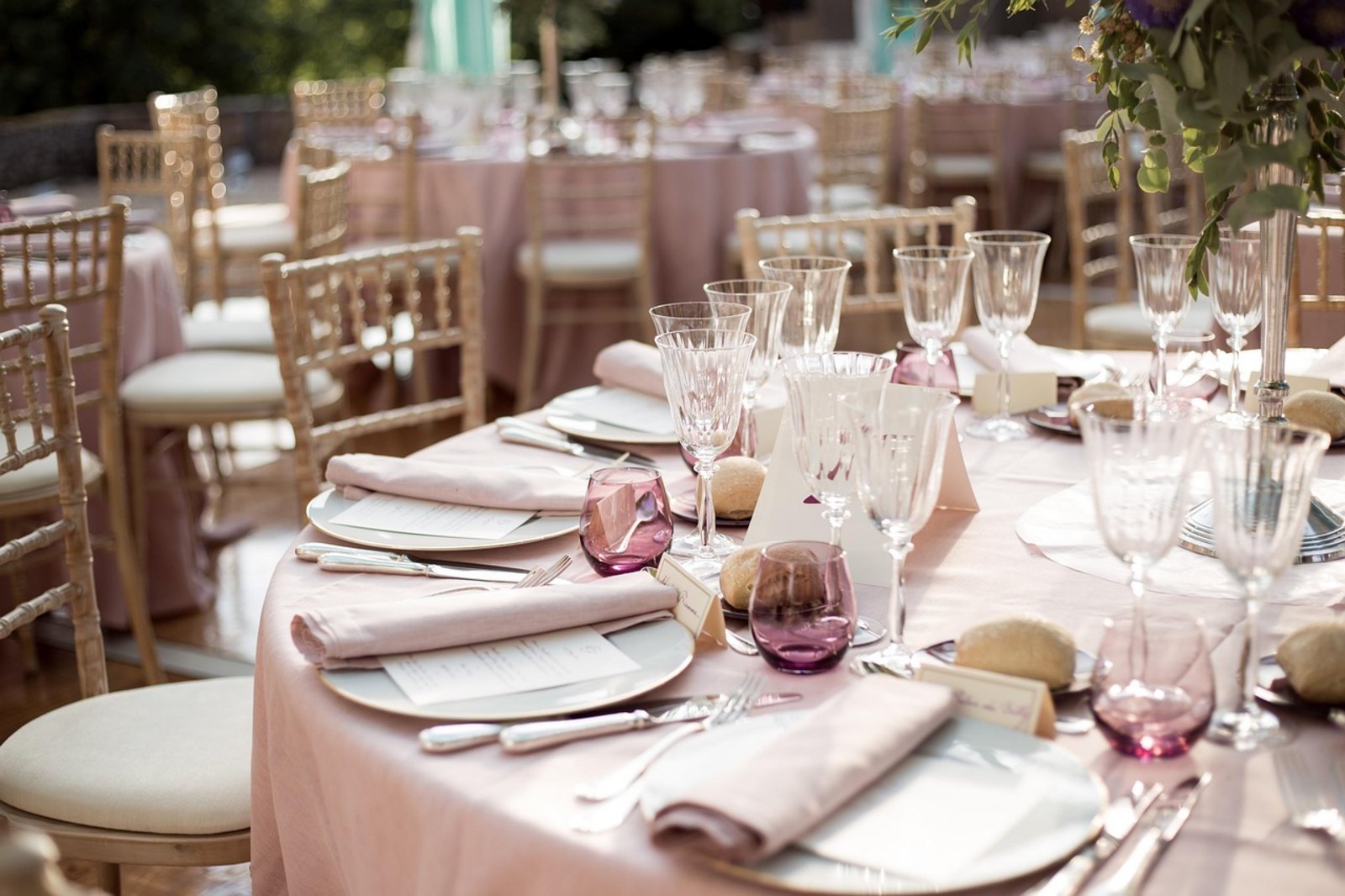 Wedding reception tablescape in Windsor with blush linens, gold chiavari chairs, crystal glassware and a tall floral centrepiece